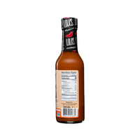 Lola's Trinidad Scorpion hot sauce in a glass bottle with a label, featuring all-natural lime and fresh garlic. 5 oz.