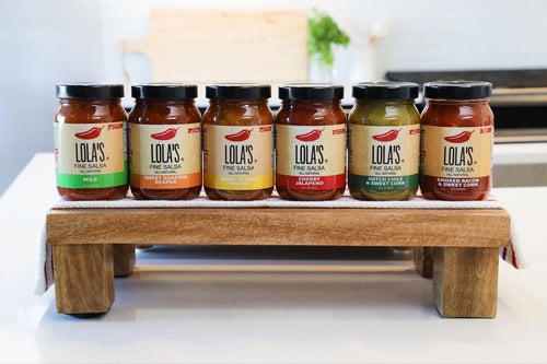 A collection of salsa jars with labels, perfect for food storage and condiments.