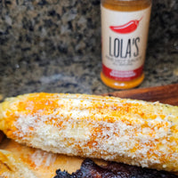 Lola's Original Seasoning: A smoky, sweet, and spicy blend with a zing of lime. Perfect for steaks, chicken, fish, popcorn, and more! 3.9 oz. plastic shaker.