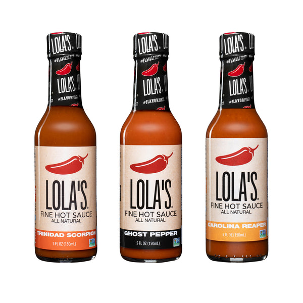 Lola's "Three Hit Wonders" Hot Sauce 3-Pack: A group of hot sauce bottles featuring Lola's signature Trinidad Scorpion, Ghost Pepper, and Carolina Reaper flavors.