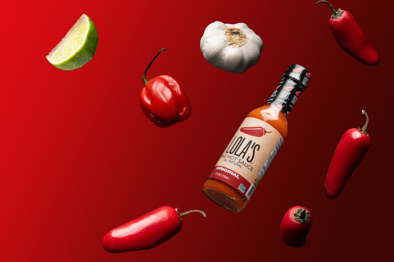 Lola's Original Hot Sauce surrounded by chilis, garlic, and lime